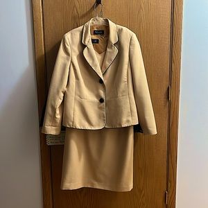 Evan Piccone yellow gold sleeveless dress with matching jacket with black trim.